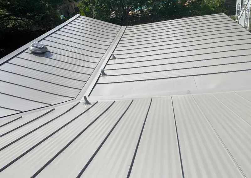 Solar attic fan installed on a metal roof for Roof Ventilation in Fort Dodge